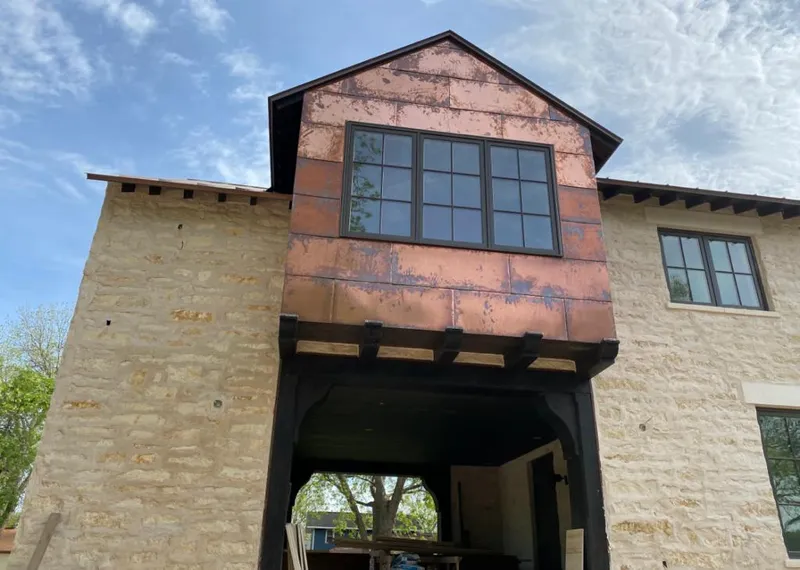 Copper metal panel facade on a stone building for Skylight Installation in Waller