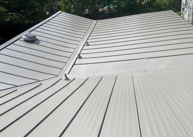 Solar attic fan installed on a metal roof for Roof Ventilation in Waller